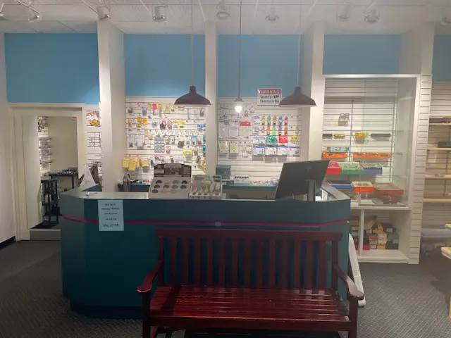 A red bench in front of a counter.