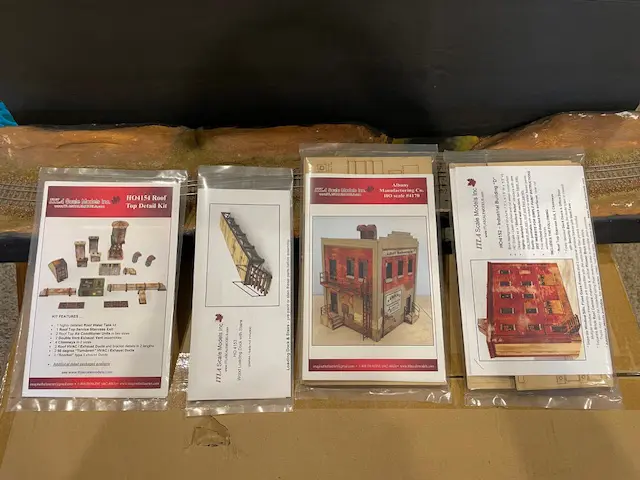 A set of four packages with instructions for making furniture.